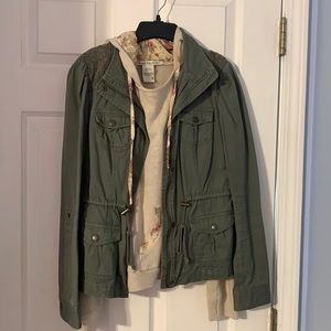 Green utility jacket and cream sweater